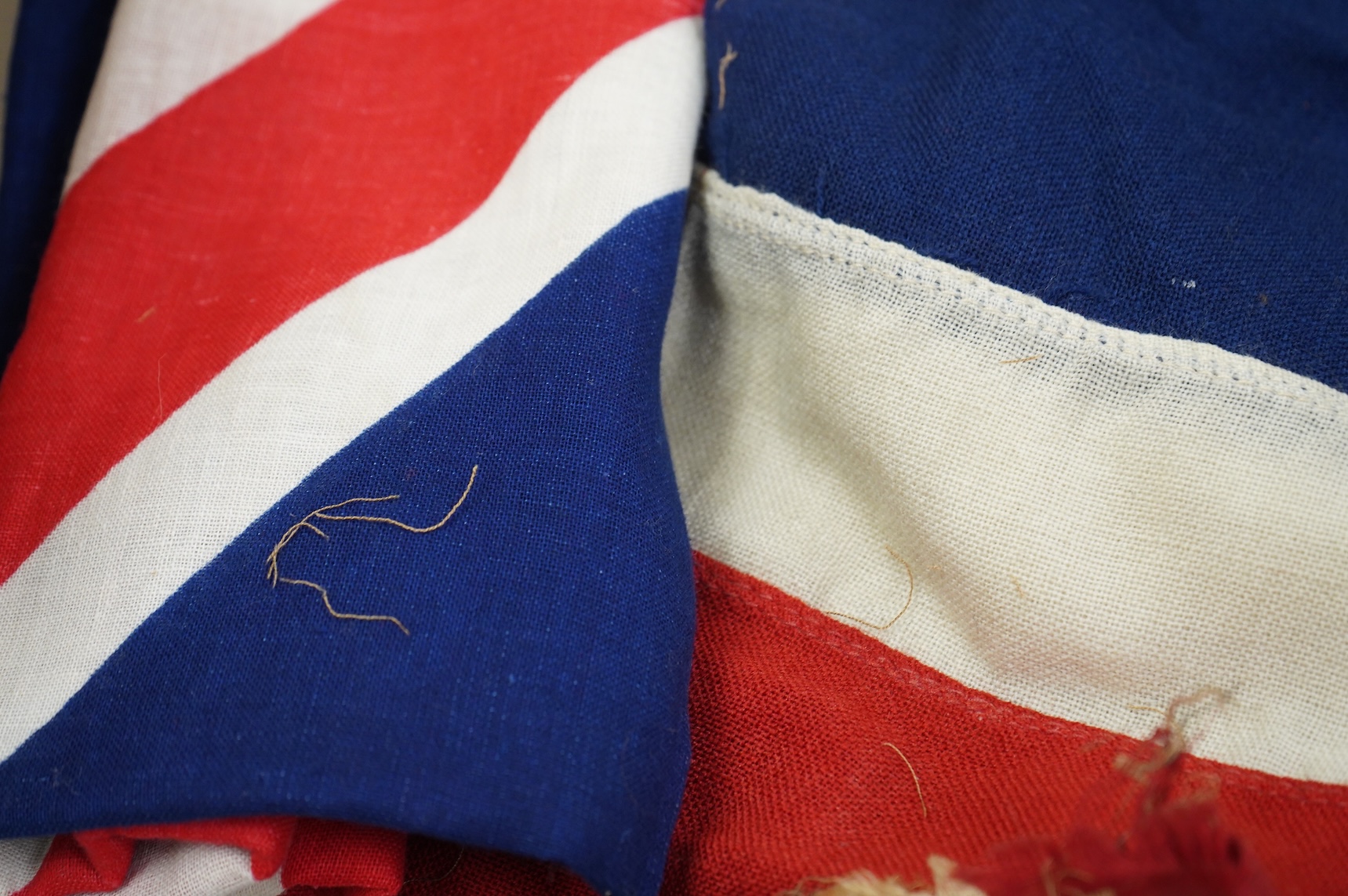 A collection of militaria, etc. including; a Gordon Highlander’s kilt and sporran, three early 20th century Union Flags, a Victorian beaded ‘sweetheart’s’ cushion, two empty First World War Princess Mary Christmas tins,